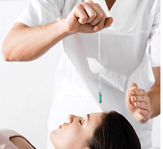 A man receives a massage while another person observes him attentively.